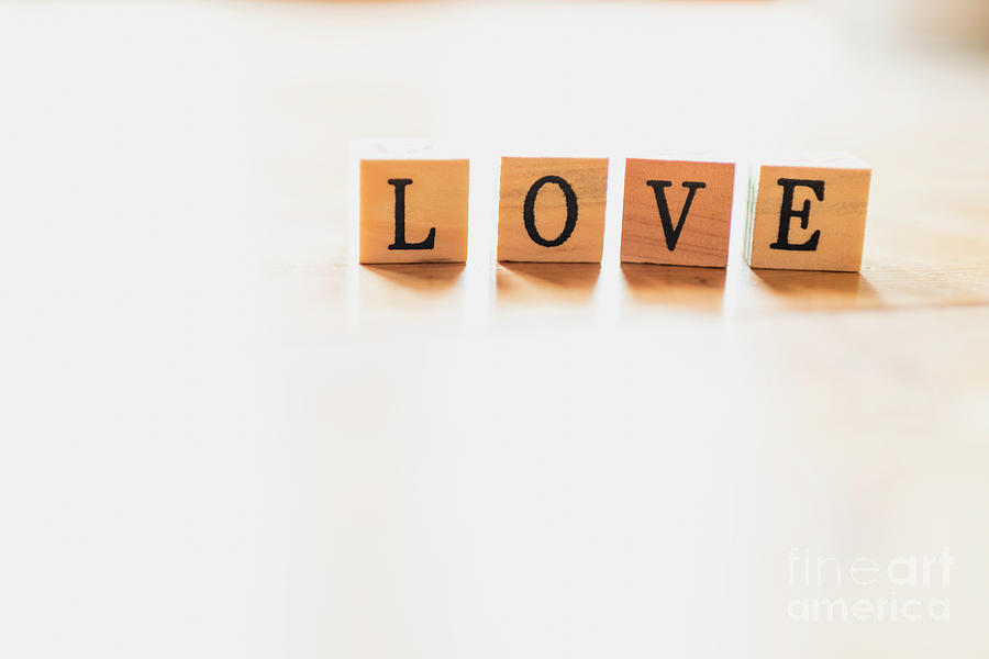 Word Love On Wooden Dice And White Background. Photograph