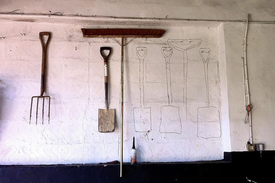 Work Tools On A Wall With Some Missing Photograph by Nigel Goodman (flickr-nigel@hornchurch)