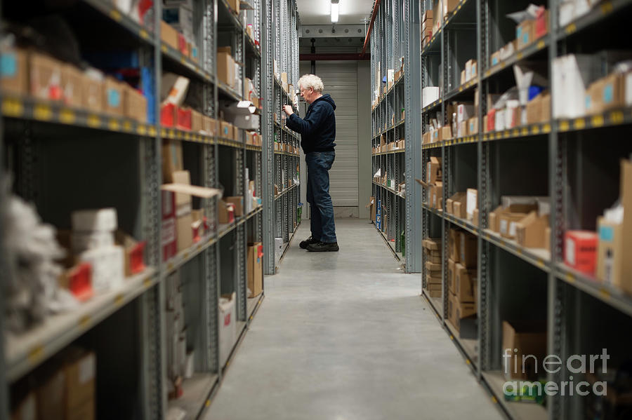 Worker Collecting A Client Order In A Warehouse Photograph by Arno Massee/science Photo Library