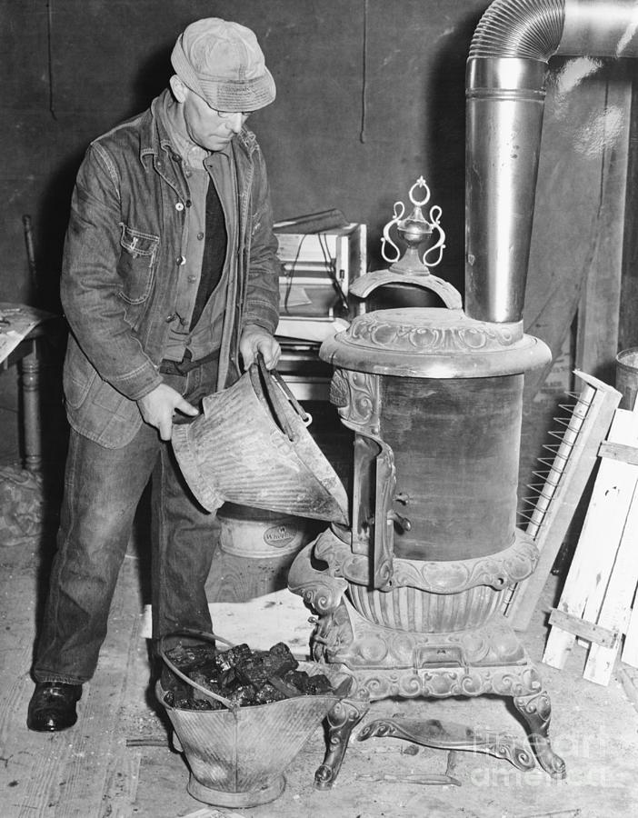 Worker Filling Stove With Coals Photograph by Bettmann