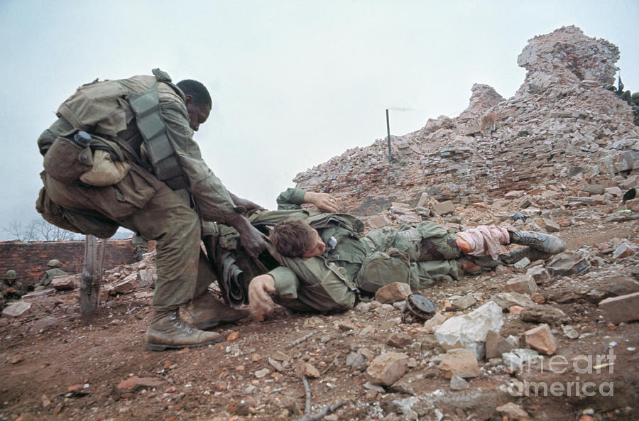 Wounded Marine Being Dragged To Safety Photograph by Bettmann