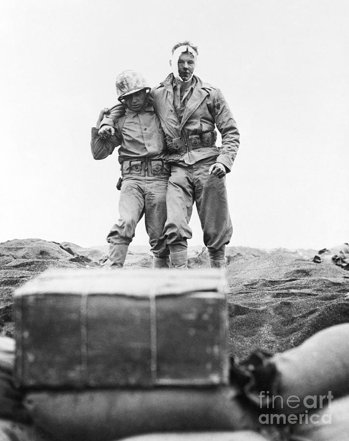 Wounded Soldier Helped To The Beach Photograph by Bettmann