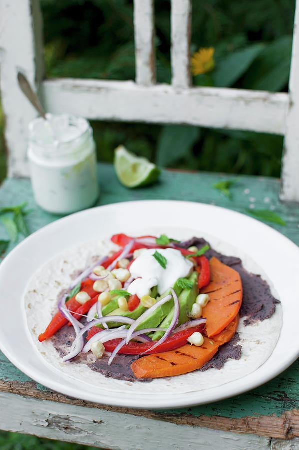 Wrap tortilla With Black Beans Paste, Roasted Pepper, Roasted Sweet Potato, Avocado, Corn Grains, Red Onion And Mint Yoghurt Sauce Photograph by Kachel Katarzyna