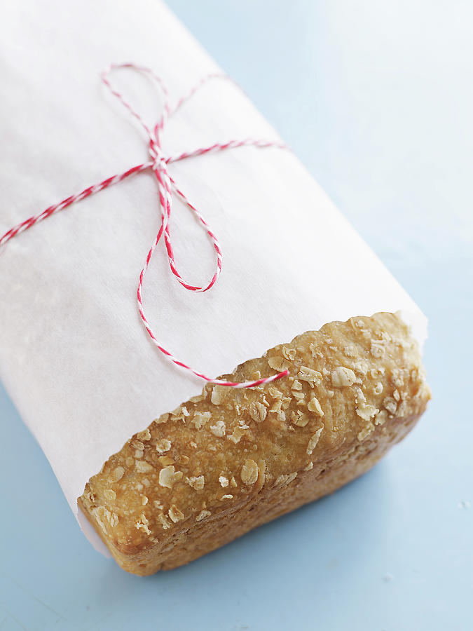 Wrapped Loaf Of Oatmeal Bread Photograph by Alexandra Grablewski