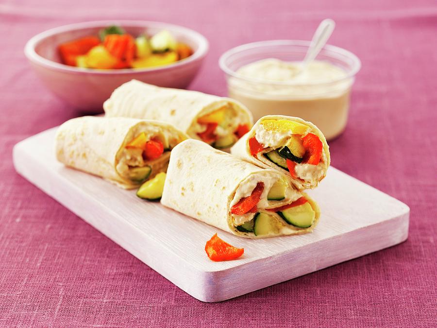 Wraps With Hummus, Courgette And Peppers On A Board Photograph by Frank Adam