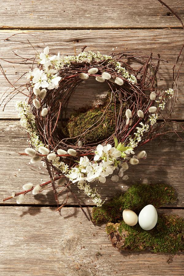 Wreath Made Of Pussy Willow And Fruit Blossom, Moss And Easter Eggs On A Wooden Surface Photograph by Heidi Frhlich