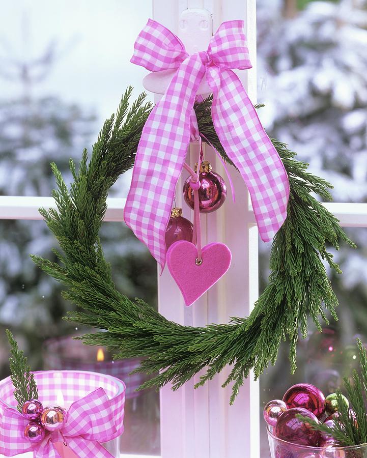 Wreath Of Japanese Cedar With Christmas Baubles & Bow At Window Photograph by Friedrich Strauss