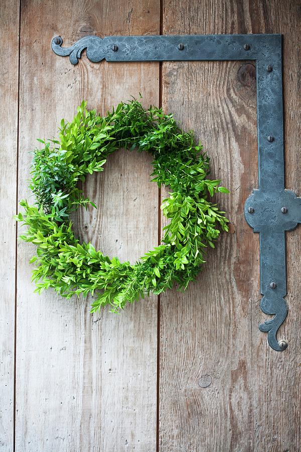 Wreath Of Myrtle And Box On Barn Door Photograph by Martina Schindler