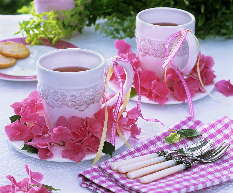 Wreath Of Pink Hydrangeas Around Mugs Of Tea Photograph by Strauss, Friedrich