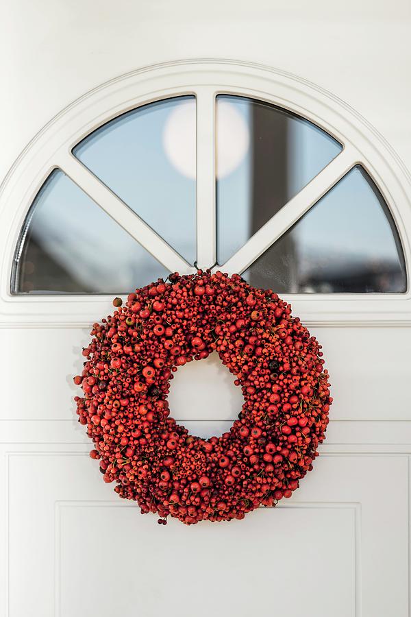 Wreath Of Red Berries Below Fanlight In Front Door Photograph by Bildhbsch