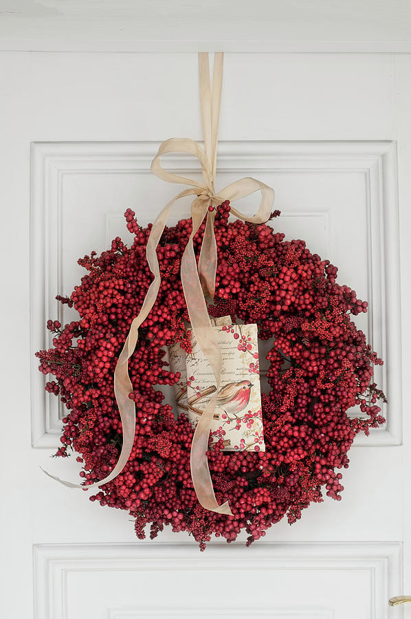 Wreath Of Red Berries With Postcard On White Door Photograph by Great Stock!