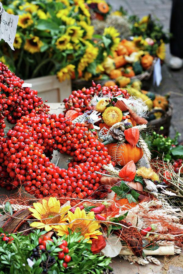 Wreath Of Rosehips And Natural Craft Utensils On An Autumn Market Stall Photograph by Alexandra Panella