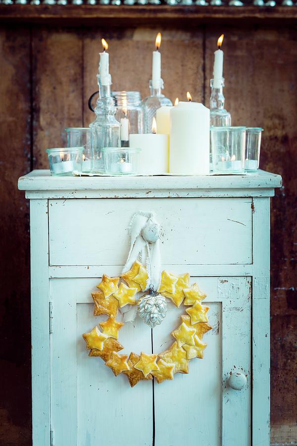 Wreath Of Shortcrust Stars And Candles On Vintage Cabinet Photograph by Eising Studio