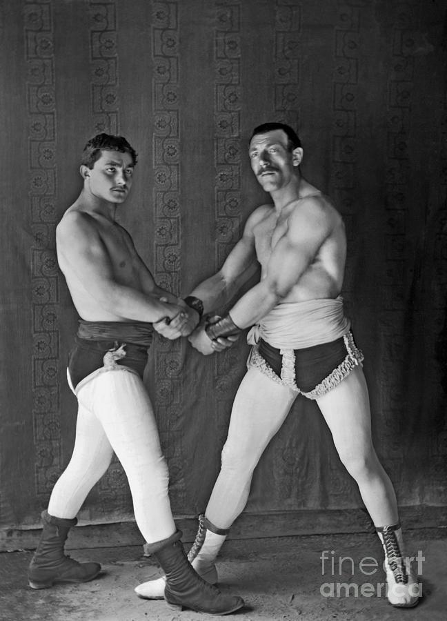 Wrestlers Of A Traveling Circus Photograph by Paul Emile Theodore Ducos