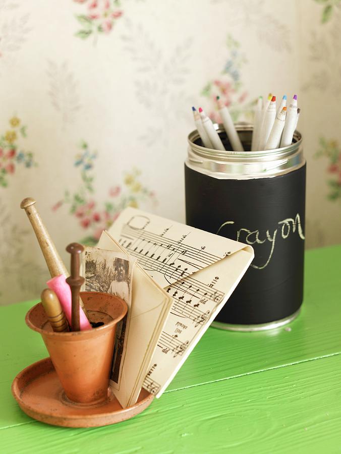 Writing Implements And Envelope With Musical Notes On A Green Surface