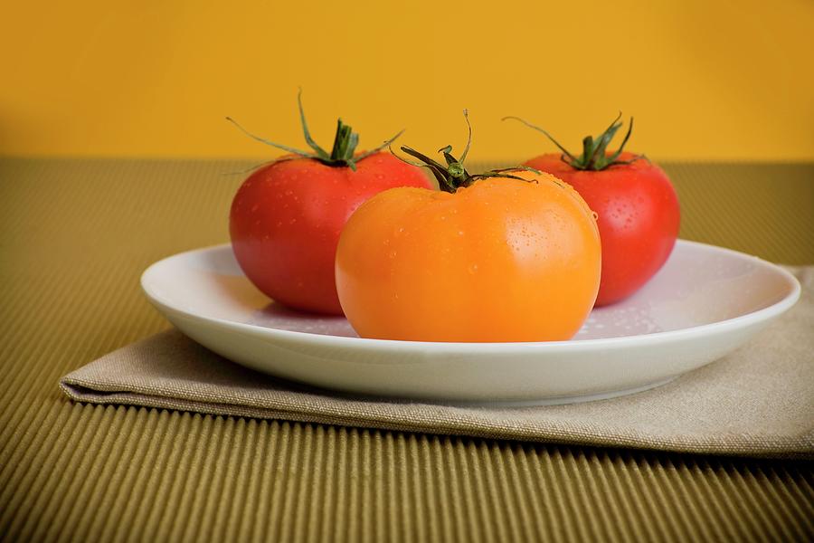 Yellow And Red Tomatoes On A White Plate Photograph by Fleischman, Richard