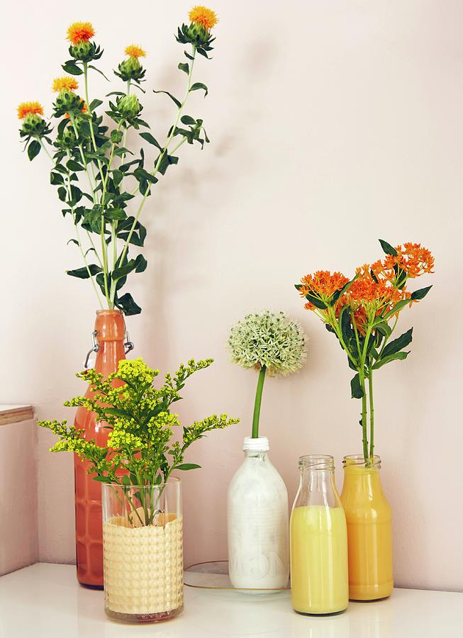 Yellow And White Flowers In Bottles And Glasses Painted Matching Colours Photograph by Nina Struve