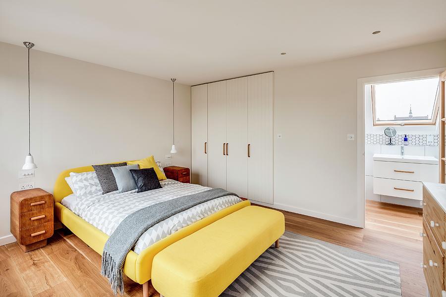 Yellow Bed And Fitted Wardrobes In Bedroom With Ensuite Bathroom Photograph by Simon Maxwell Photography
