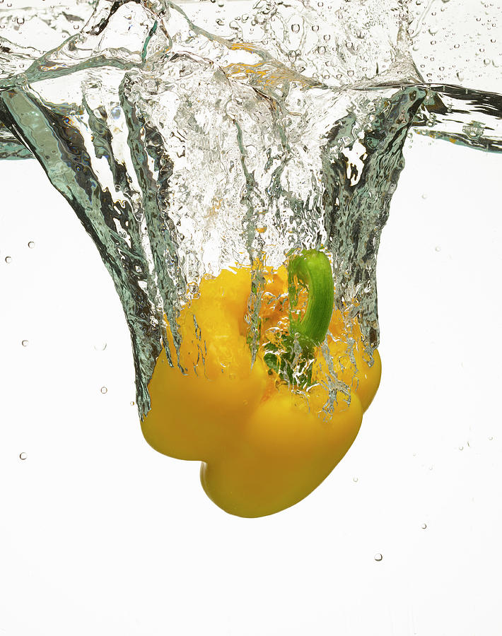 Yellow Bell Pepper Splashing In Water Photograph by Don Farrall