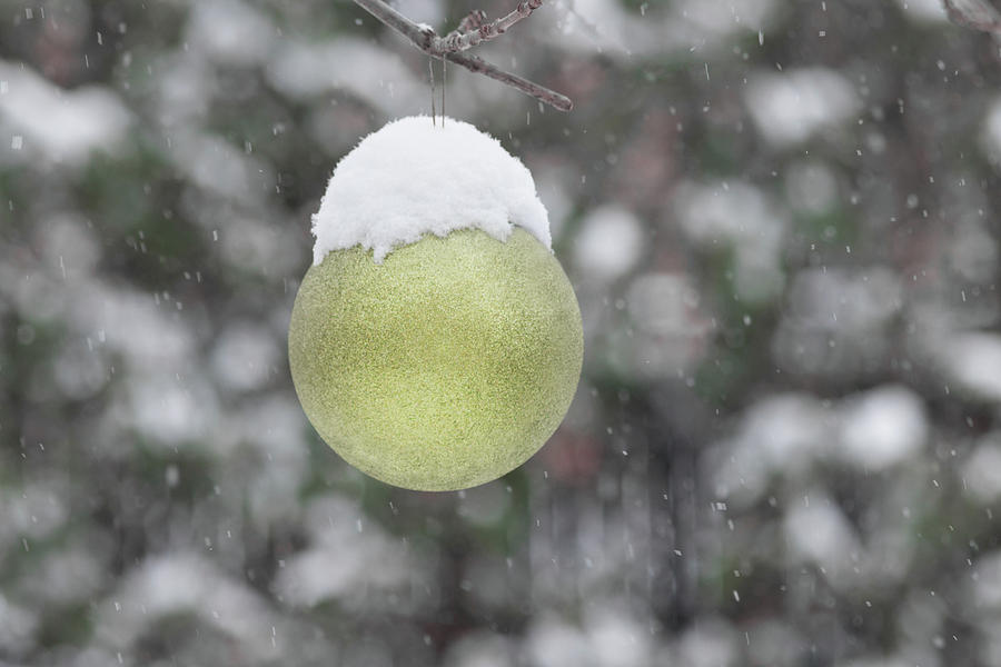 Yellow Christmas ball outside, covered by snow. Outside snowy wi Photograph by Cristina Stefan