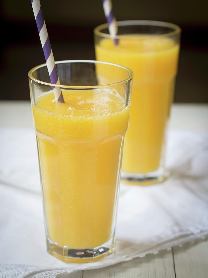 Yellow Exotic Fruit Smoothies In Glasses With Straws Photograph by Magdalena Paluchowska