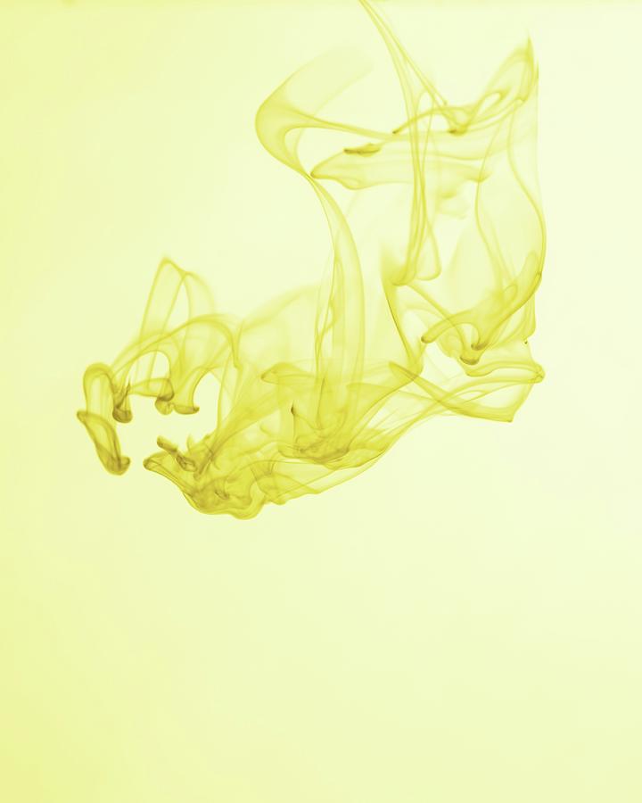 Yellow Ink Dripping Into Water Photograph by Krger & Gross