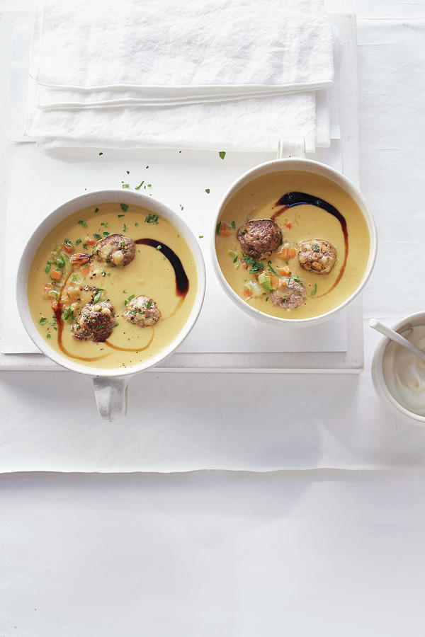 Yellow Lentil Soup With Cider, Leek Strips, And Mince And Cheese Balls Photograph by Jan-peter Westermann