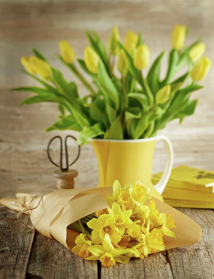 Yellow Narcissus Wrapped In Paper And Yellow Tulips In Ceramic Jug Photograph by Michael Lffler