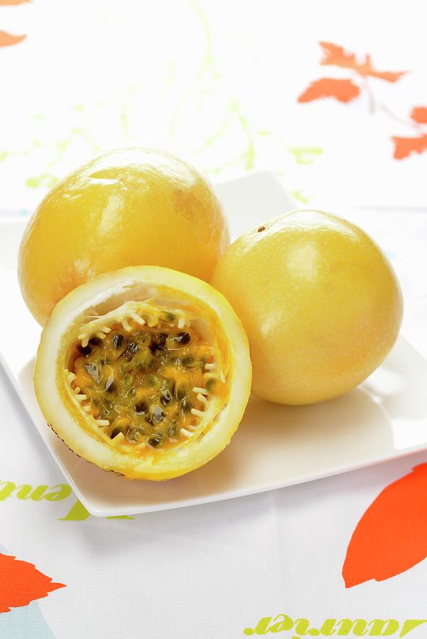 Yellow Passion Fruit, Whole And Cut In Half Photograph by Alain Caste