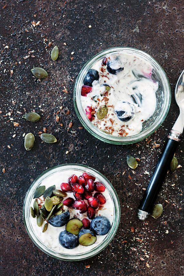 Yoghurt With Flax Seeds, Blueberries, Pomegranate Seeds And Pumpkin Seeds Photograph by Birgit Twellmann