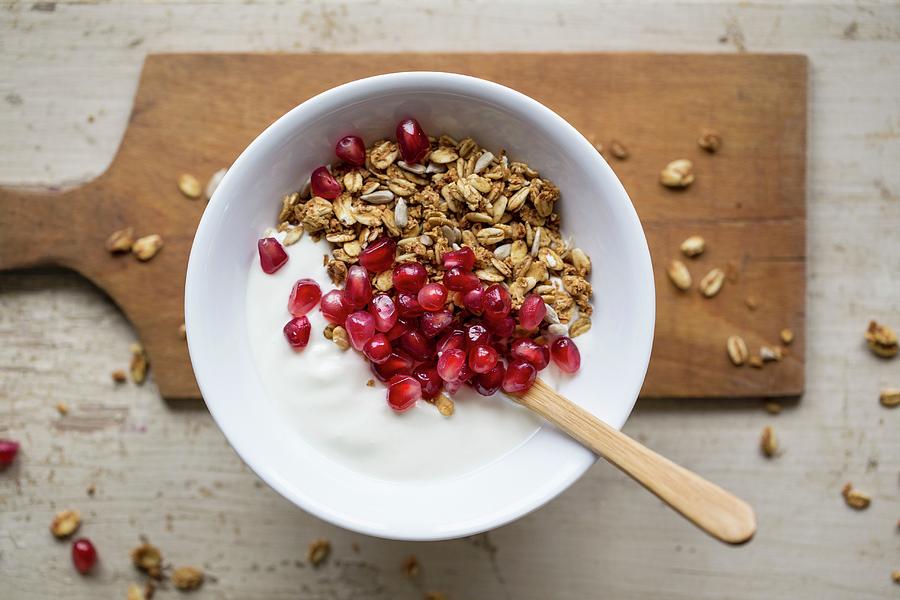 Yoghurt With Granola And Pomegranate Seeds Photograph by Nicole Godt