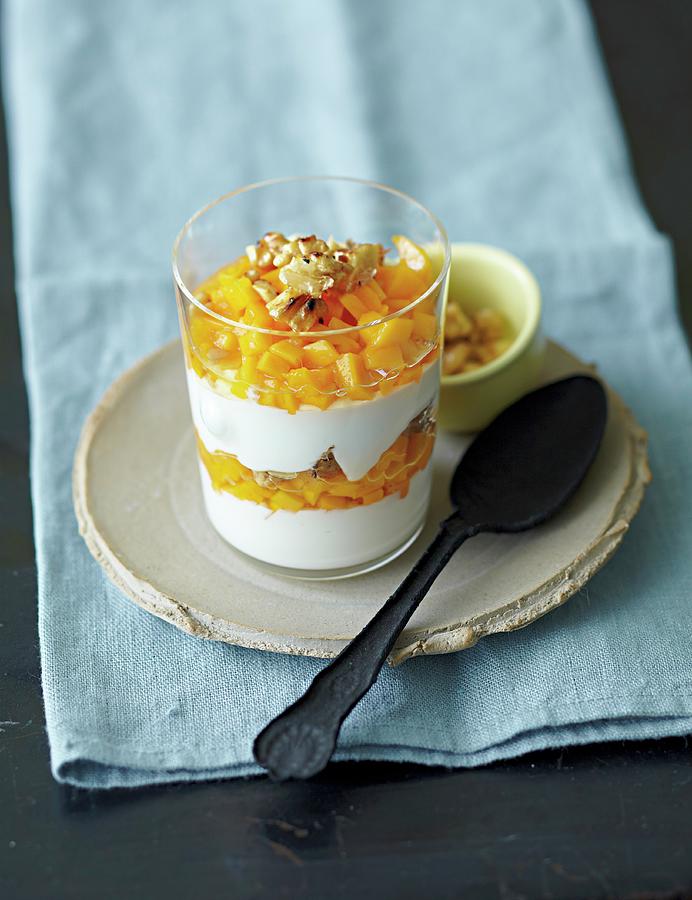 Yogurt Cream With Mango And Walnuts Photograph by Jalag / Janne Peters