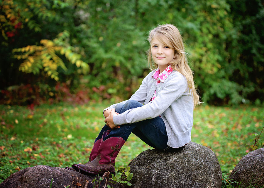 Nature Photograph - Young Blond Girl In Red Cowboy Boots Sitting Outside On A Rock by Cavan Images