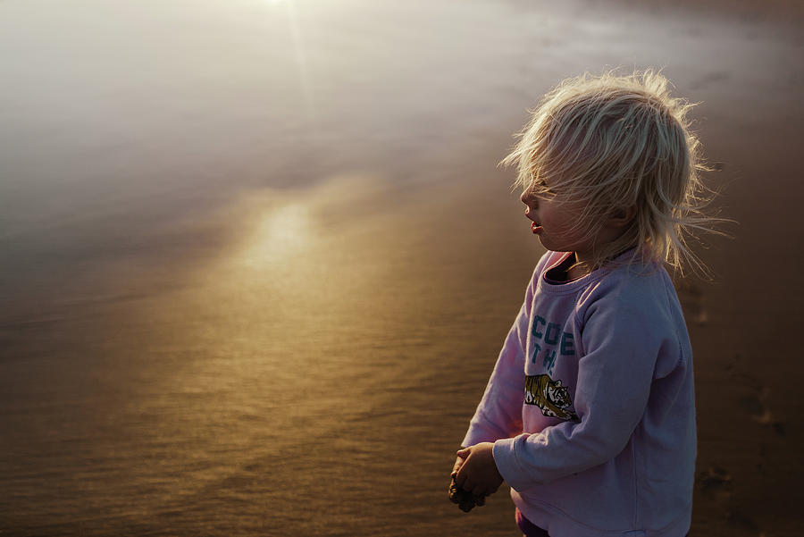 Sunset Photograph - Young Blond Girl Standing On The Beach At Sunset In Australia by Cavan Images