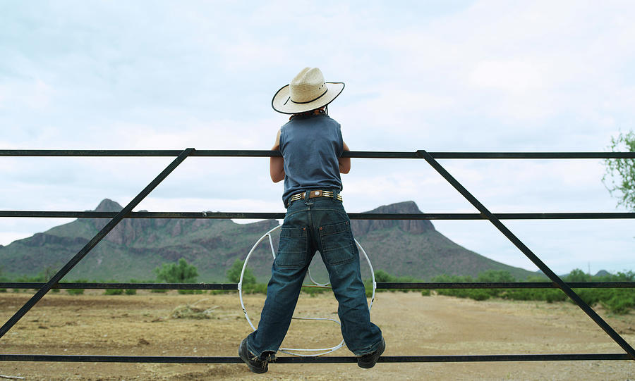 Young Boy 7-8 Standing On Ranch Railing Photograph by John Slater