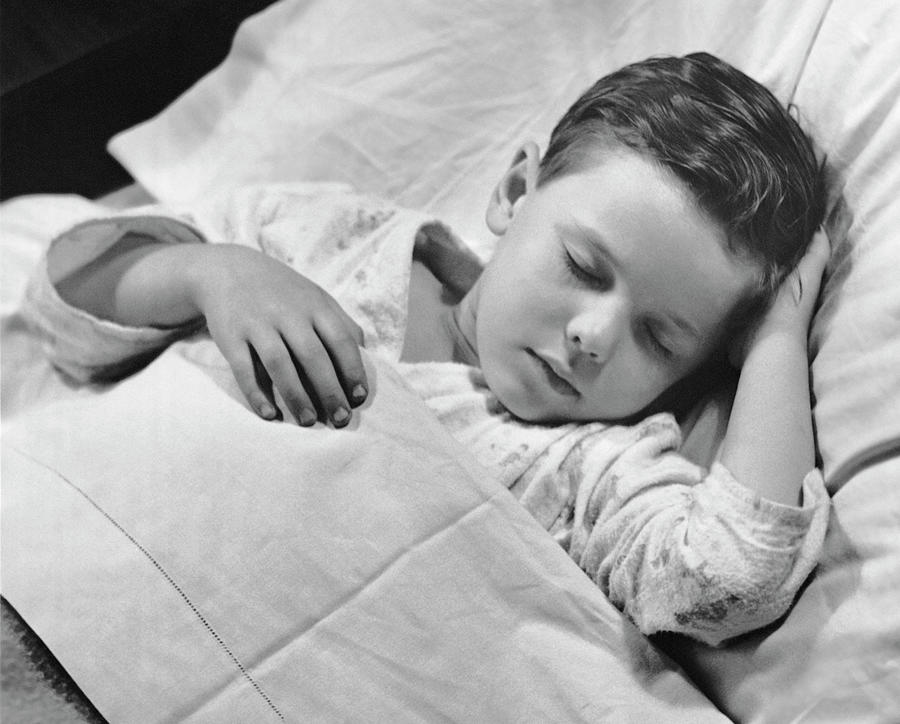 Young Boy Asleep In Bed Photograph by George Marks