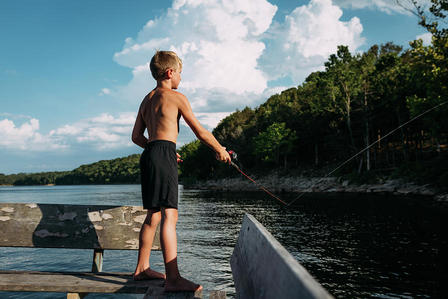 Fish Photograph - Young Boy Fishing Off Dock On Sunny Summer Day by Cavan Images / Krista Taylor