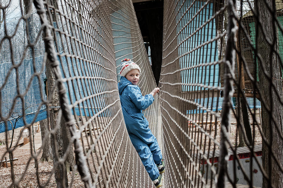 Young Boy Playing On A Net At An Outdoor Playground Photograph by Cavan ...