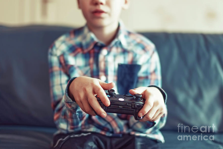 Young Boy Playing Video Game Photograph by Sakkmesterke/science Photo Library