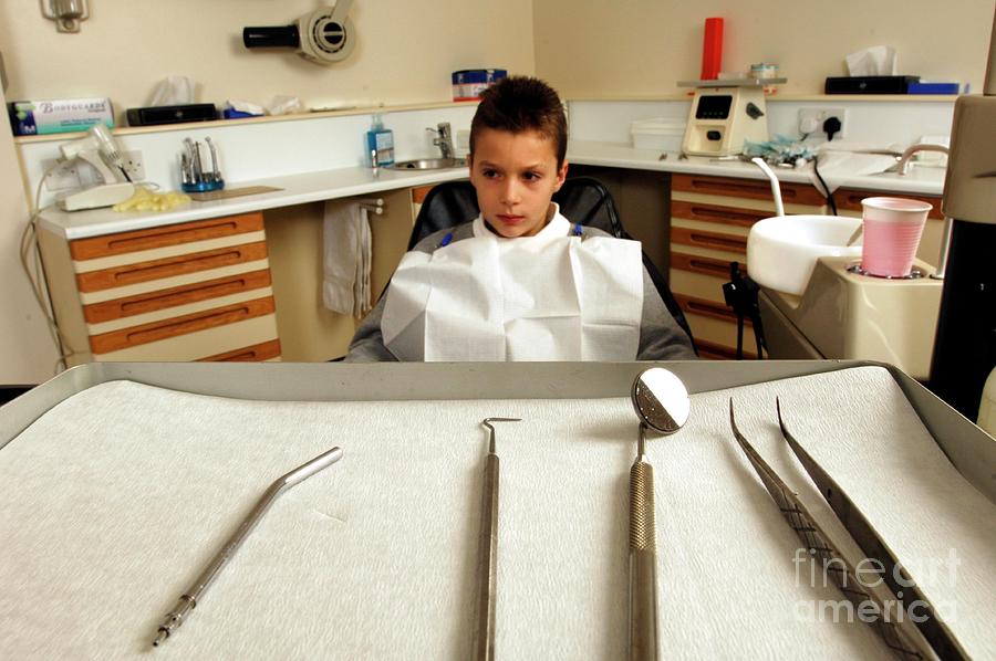 Young Boy Sitting In Dentists Chair Photograph by Medicimage / Science Photo Library