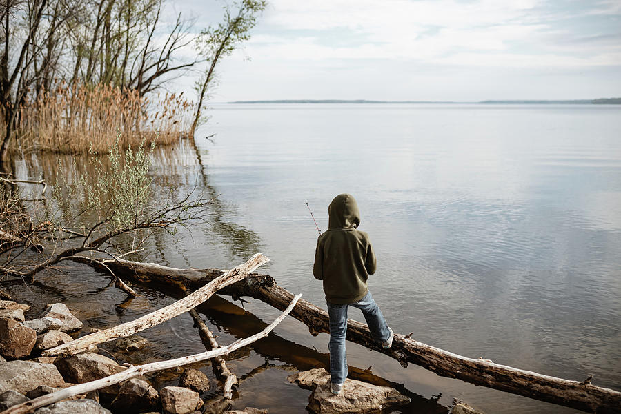 Spring Photograph - Young Boy Standing Lakeside Fishing During Spring by Cavan Images / Krista Taylor