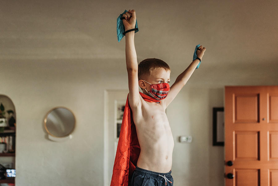 Halloween Photograph - Young Boy With Arms Outstretched Wearing Superhero Costume And Mask by Cavan Images