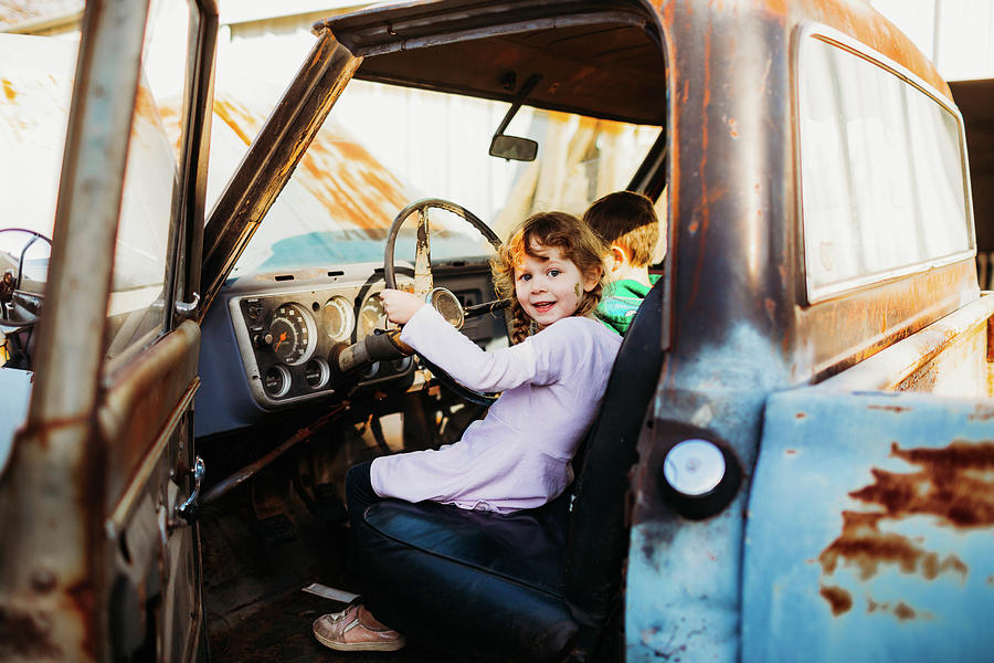 Young Brother And Sister Sitting In Vintage Truck At Sunset Photograph ...