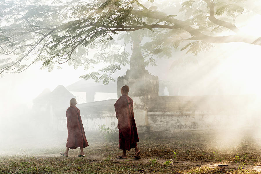 Young Buddhist Monks Walking Along Path Photograph by Martin Puddy