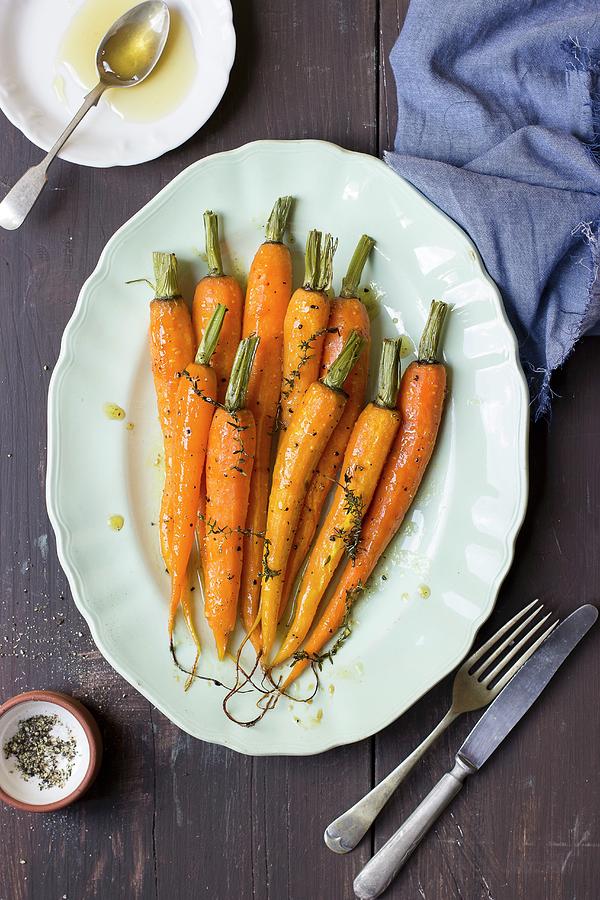 Young Carrots With Honey, Lemon, Thyme And Olive Oil Photograph by Zuzanna Ploch