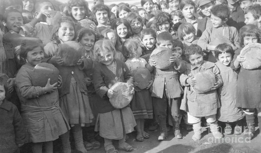 Young Children Holding Loaves Of Bread Photograph by Bettmann