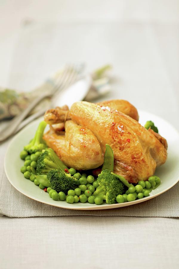 Young Cockerel With Peas, Broccolis And Sugar Peas Photograph by Bagros
