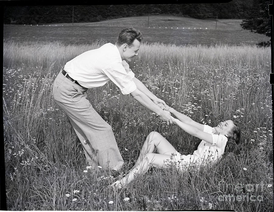 Young Couple Frolicking In Grass Photograph by Bettmann