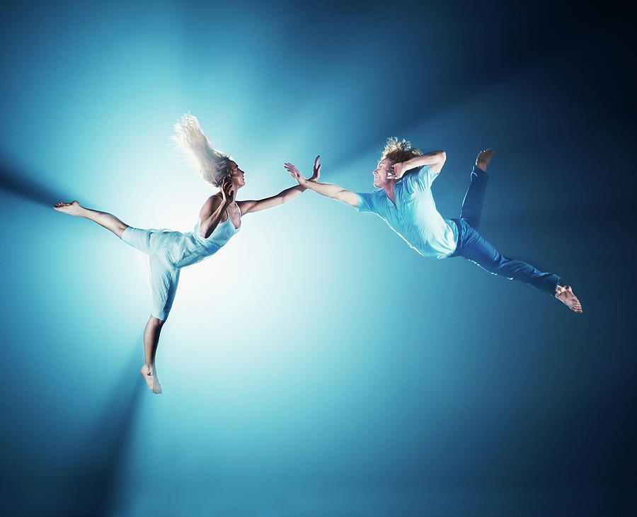 Young Men Photograph - Young Couple In Air, Low Angle View by Henrik Sorensen Young Men Photograph - Young Couple In Air, Low Angle View by Henrik Sorensen