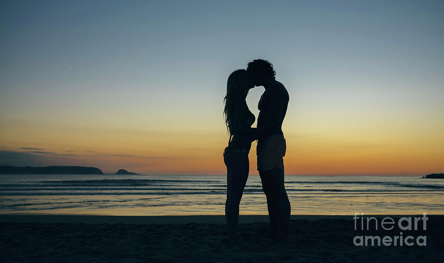 Young Couple Kissing On The Beach Photograph by Westend61
